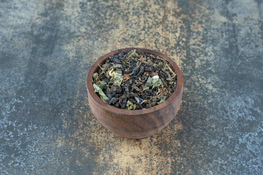 herbal tea leaves in wooden bowl